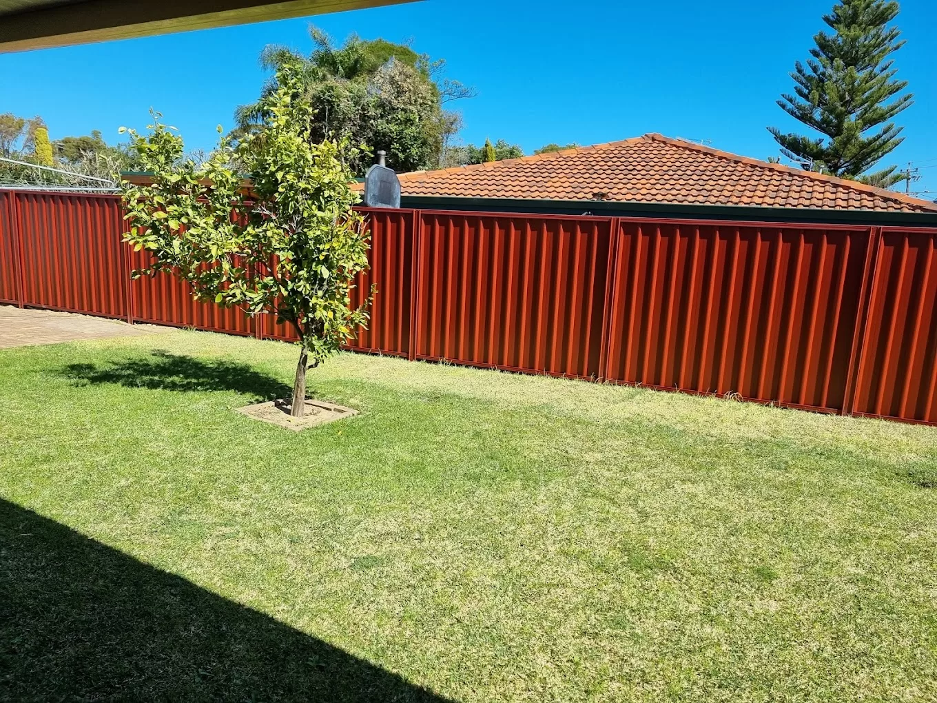 A colobond fence between houses.