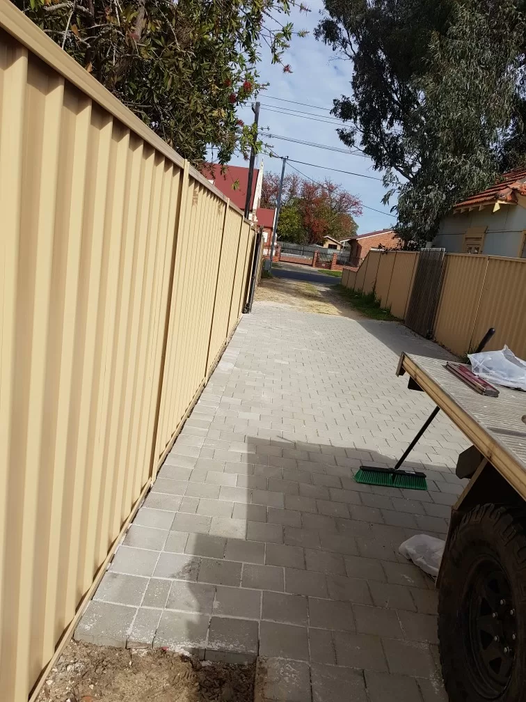 Fencing contractors installing a colorbond fence.